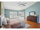 Comfortable main bedroom featuring hardwood floors, neutral colors, and a ceiling fan at 16910 Equestrian Trl, Odessa, FL 33556