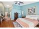 Large main bedroom with hardwood floors, accent wall, and ample natural light at 16910 Equestrian Trl, Odessa, FL 33556