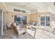 Covered patio featuring comfortable seating and views of the screened-in pool area at 16910 Equestrian Trl, Odessa, FL 33556