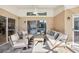 Inviting covered patio with neutral furniture, offering a relaxing view of the pool area at 16910 Equestrian Trl, Odessa, FL 33556