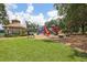 Community playground featuring multiple slides, a gazebo, and a tennis court in the background at 16910 Equestrian Trl, Odessa, FL 33556