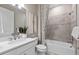Well-lit bathroom featuring a shower-tub, single sink vanity, and modern fixtures at 17206 Luminous Ave, Venice, FL 34293