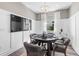 Bright game room featuring a poker table, elegant chandelier, and large window for natural light at 17206 Luminous Ave, Venice, FL 34293
