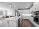 Modern kitchen with a spacious island, stainless steel appliances, and open layout to the living area at 17206 Luminous Ave, Venice, FL 34293
