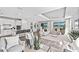 Open-concept living space showcasing a modern kitchen, dining area, and comfortable seating with abundant natural light at 17206 Luminous Ave, Venice, FL 34293