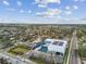 Aerial view of SARC with a pool, boat dock, parking lot, and large trees on a bright sunny day at 1735 Maryland Ne Ave, St Petersburg, FL 33703