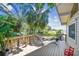 Back deck with a hammock, palm trees, decorative lighting and views of the lush backyard at 1735 Maryland Ne Ave, St Petersburg, FL 33703