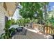 Spacious wooden deck featuring a seating area, stainless grill, and plenty of green plants for privacy at 1735 Maryland Ne Ave, St Petersburg, FL 33703