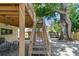 A backyard with patio seating below the stairs from the deck to the fenced backyard at 1735 Maryland Ne Ave, St Petersburg, FL 33703