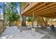 Backyard featuring white gravel, mature trees, and a swing under the wooden deck and stairs at 1735 Maryland Ne Ave, St Petersburg, FL 33703
