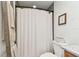 Bathroom with a toilet, shower with neutral curtain, and ladder for hanging towels at 1735 Maryland Ne Ave, St Petersburg, FL 33703