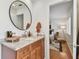 Well-lit bathroom with a granite vanity, modern fixtures, and a glimpse into the Primary bedroom at 1735 Maryland Ne Ave, St Petersburg, FL 33703