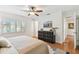 Bright bedroom features a ceiling fan, wood floors, a textured dresser and large windows with shutters at 1735 Maryland Ne Ave, St Petersburg, FL 33703