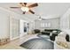Comfortable Gathering room with bright light, featuring a large, green sectional and playroom decorations at 1735 Maryland Ne Ave, St Petersburg, FL 33703