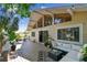 A spacious wooden deck with an outdoor couch, plants, and a view of lush tropical foliage at 1735 Maryland Ne Ave, St Petersburg, FL 33703
