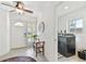 Foyer featuring front door, tile flooring, ceiling fan and bench adjacent to the laundry room at 1735 Maryland Ne Ave, St Petersburg, FL 33703