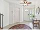 Inviting foyer with tiled floor, ceiling fan and front door plus a bench with storage at 1735 Maryland Ne Ave, St Petersburg, FL 33703