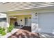 Close-up of the home entrance and garage, featuring light beige siding and garden at 1735 Maryland Ne Ave, St Petersburg, FL 33703