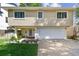 Charming two-story home featuring a well-manicured lawn, classic siding, and an attached two-car garage at 1735 Maryland Ne Ave, St Petersburg, FL 33703