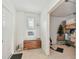 Hallway features a wooden chest beneath a window and leads to a storage room, with tiled flooring at 1735 Maryland Ne Ave, St Petersburg, FL 33703