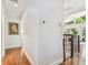 Hallway with hardwood floors, a modern painting and natural light through a doorway to the deck at 1735 Maryland Ne Ave, St Petersburg, FL 33703