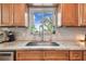 Bright kitchen sink area with a view to the outside, set in beautiful, well-maintained cabinetry at 1735 Maryland Ne Ave, St Petersburg, FL 33703