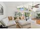 Inviting living room featuring a plush sectional sofa, neutral decor, and bright natural light at 1735 Maryland Ne Ave, St Petersburg, FL 33703