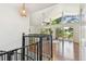 Bright living room viewed from the staircase with hardwood floors, high ceilings, and abundant natural light at 1735 Maryland Ne Ave, St Petersburg, FL 33703