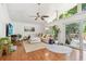 Spacious living room featuring hardwood floors, a large sectional, and ample natural light at 1735 Maryland Ne Ave, St Petersburg, FL 33703