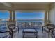 Covered balcony with seating, overlooking the community pool and waterfront at 17735 Gulf Blvd # 202, Redington Shores, FL 33708