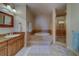Relaxing primary bathroom featuring a garden tub and glass enclosed shower at 17735 Gulf Blvd # 202, Redington Shores, FL 33708