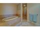 Primary bathroom featuring a garden tub and a glass enclosed shower at 17735 Gulf Blvd # 202, Redington Shores, FL 33708