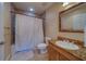 Bathroom features a shower with curtain, granite vanity and tile flooring at 17735 Gulf Blvd # 202, Redington Shores, FL 33708