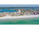 Scenic aerial view of beach featuring white sands and clear blue water, showcasing nearby condominiums at 17735 Gulf Blvd # 202, Redington Shores, FL 33708