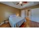 Bedroom features a tray ceiling, fan, and hardwood floor at 17735 Gulf Blvd # 202, Redington Shores, FL 33708