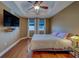 Bedroom features a tray ceiling, fan, hard wood floor, and TV at 17735 Gulf Blvd # 202, Redington Shores, FL 33708