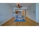 Open dining room with seating for four, hardwood floors, and views to the kitchen at 17735 Gulf Blvd # 202, Redington Shores, FL 33708