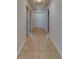 Long hallway features tile flooring and neutral paint at 17735 Gulf Blvd # 202, Redington Shores, FL 33708