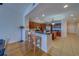 Open-concept kitchen featuring custom cabinetry, a cozy breakfast bar, and stainless steel appliances at 17735 Gulf Blvd # 202, Redington Shores, FL 33708