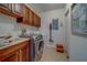 Convenient laundry room features wood cabinets, sink, and updated washer/dryer at 17735 Gulf Blvd # 202, Redington Shores, FL 33708