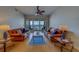 Bright and airy living room featuring comfortable leather sofas, and floor-to-ceiling sliding doors to a private balcony at 17735 Gulf Blvd # 202, Redington Shores, FL 33708
