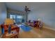 Warm and inviting living room featuring comfortable leather furniture, water views, and a ceiling fan at 17735 Gulf Blvd # 202, Redington Shores, FL 33708