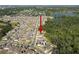 Community aerial view showcasing single Gathering homes, landscaping, and nearby lakes and forested areas at 1823 Moon Cactus Ct, Ruskin, FL 33570