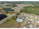 Aerial view of a neighborhood pool and basketball court alongside community homes and lakes at 1823 Moon Cactus Ct, Ruskin, FL 33570