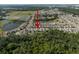 Community aerial view showcasing single Gathering homes, landscaping, and nearby lakes and forested areas at 1823 Moon Cactus Ct, Ruskin, FL 33570