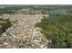 Community aerial view showcasing single Gathering homes, landscaping, and nearby lakes and forested areas at 1823 Moon Cactus Ct, Ruskin, FL 33570
