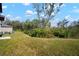 Lush backyard with mature trees and landscaping, creating a private outdoor space at 1823 Moon Cactus Ct, Ruskin, FL 33570