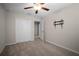 Comfortable bedroom featuring carpet, a ceiling fan, closet, and easy access to the hallway at 1823 Moon Cactus Ct, Ruskin, FL 33570