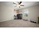 Functional bedroom featuring carpet, a ceiling fan, a bright window, and a dedicated workspace at 1823 Moon Cactus Ct, Ruskin, FL 33570