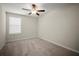 Cozy bedroom with neutral carpet, bright window, and fresh paint ready for your personal touch at 1823 Moon Cactus Ct, Ruskin, FL 33570